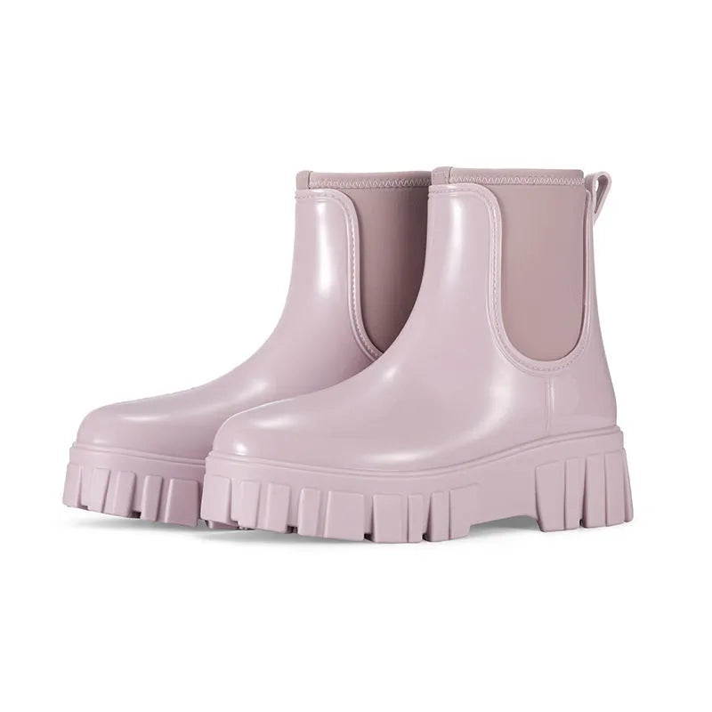 A pair of low tube PVC rain boots with a flat heel, shown in a solid colour on a white background.