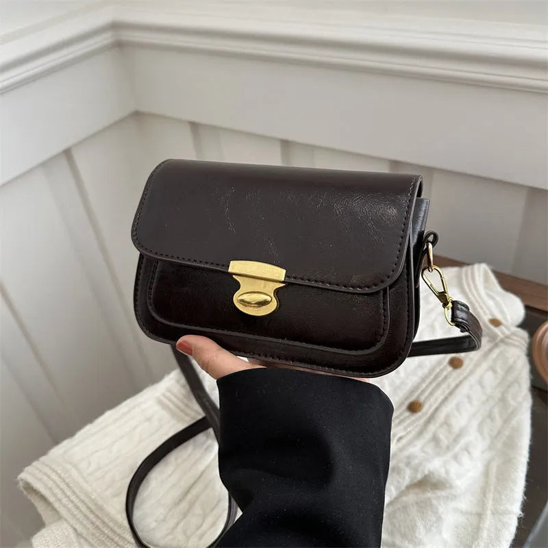 Small horizontal square handbag in soft PU leather, shown in black, brown, dark brown, and light brown.