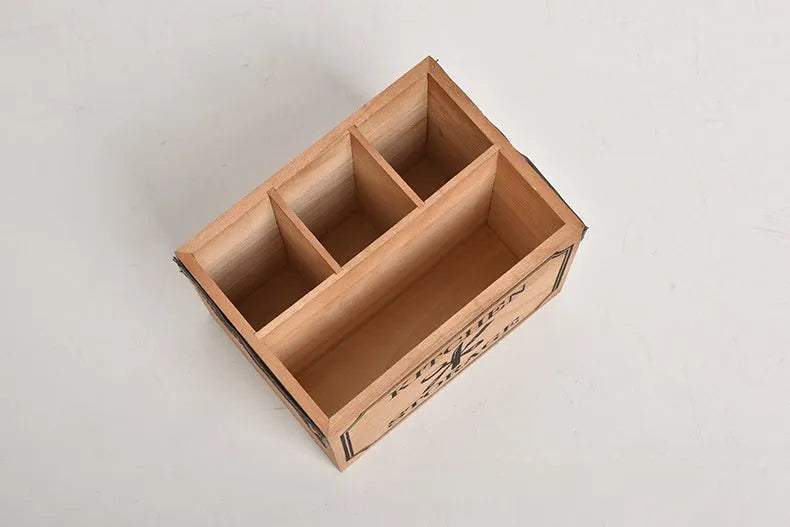 Open wooden kitchen storage box with grid divider for knives, forks, and chopsticks.