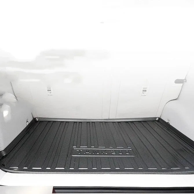 Black carbon fibre pattern TPE car boot liner mat for vehicle trunk protection.