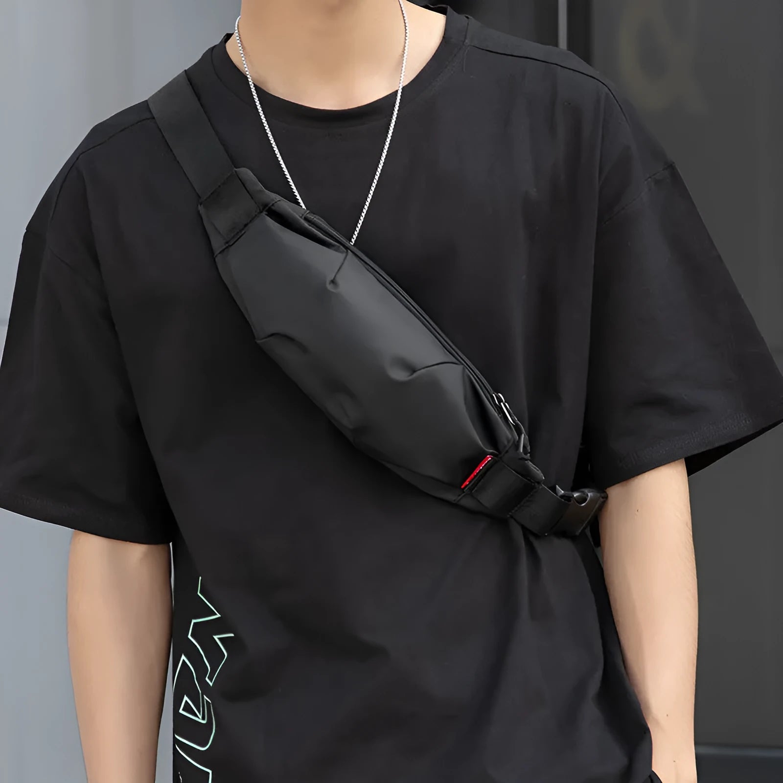 Men's black Oxford cloth crossbody waist pack showing front zipper and compact dimensions