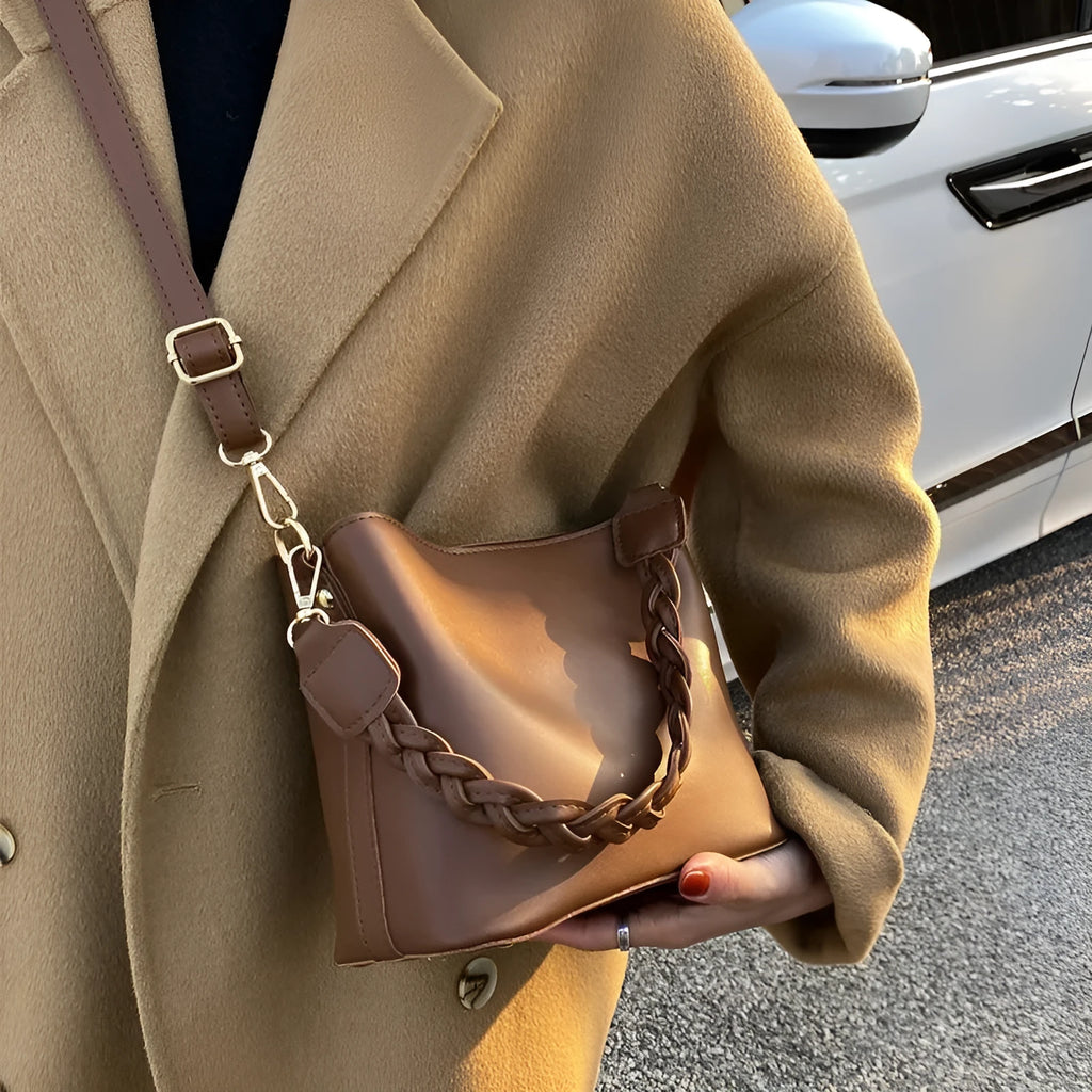 Retro woven PU leather bucket bag in khaki colour with crossbody strap.