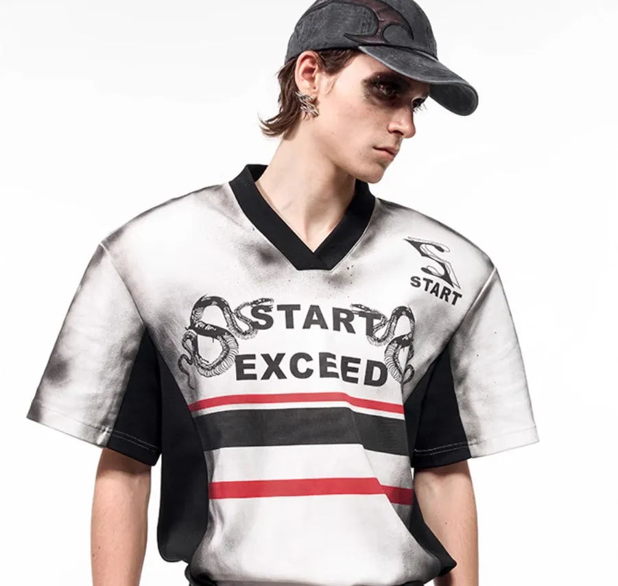 Women's short sleeve V-neck blouse with snake letter pattern print and padded shoulders.