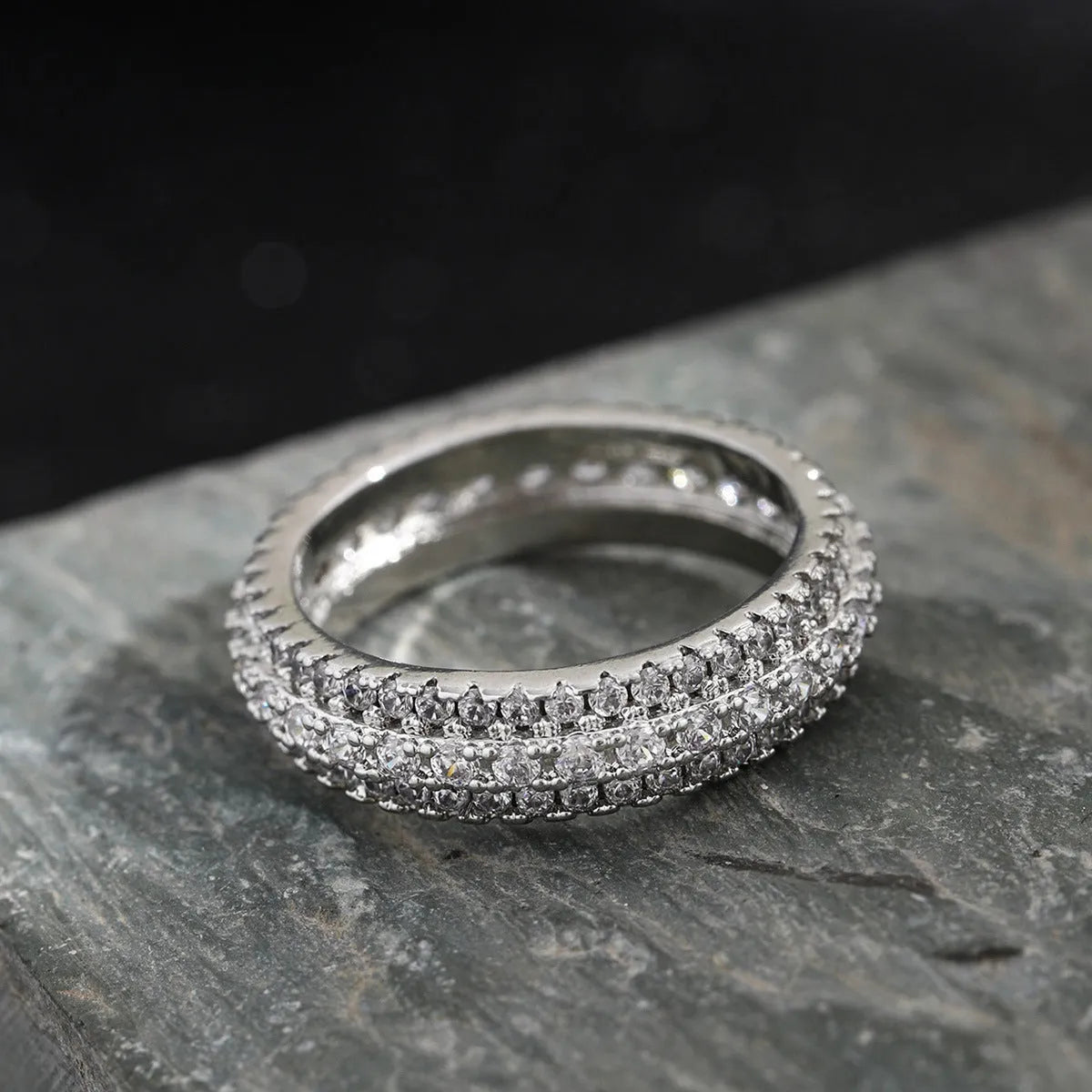 Personalised geometric triangle engagement ring with zircon inlay on a copper band.