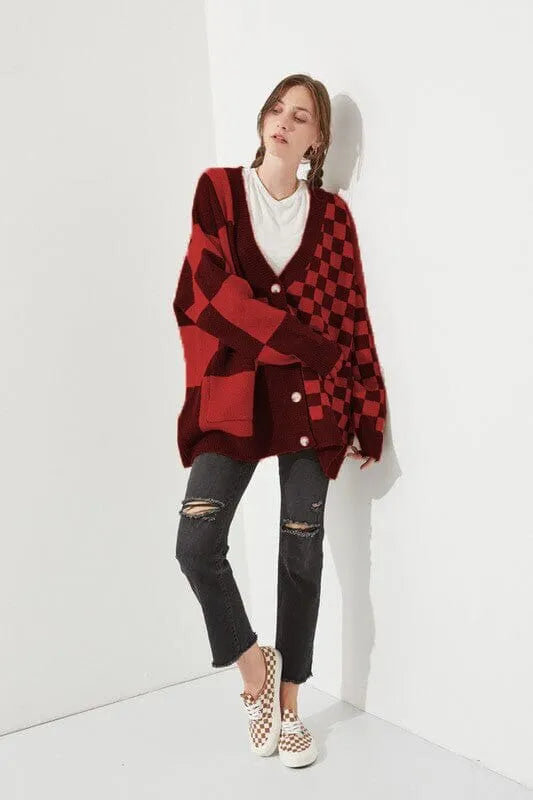 Loose fit knitwear cardigan with checks print in a selection of colours on a hanger.