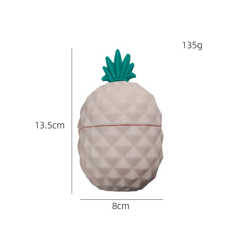 Silicone facial ice mold in pineapple style, pink colour, with ice cubes on a white background