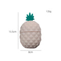 Silicone facial ice mold in pineapple style, pink colour, with ice cubes on a white background
