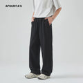A pair of men's loose-fitting grey casual trousers with a high waist and straight leg on a plain background.