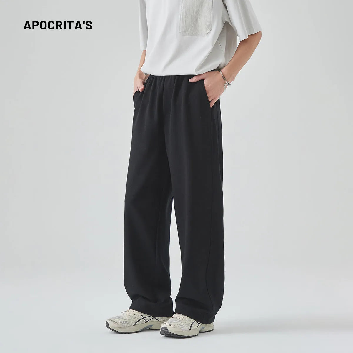 A pair of men's loose-fitting grey casual trousers with a high waist and straight leg on a plain background.