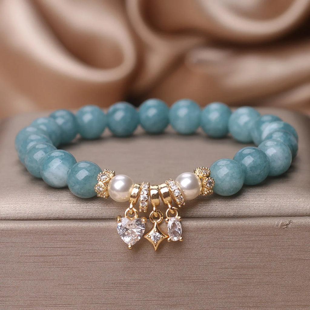Blue water jade bracelet with heart-shaped zircon pendant and agate beads on display