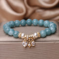 Blue water jade bracelet with heart-shaped zircon pendant and agate beads on display