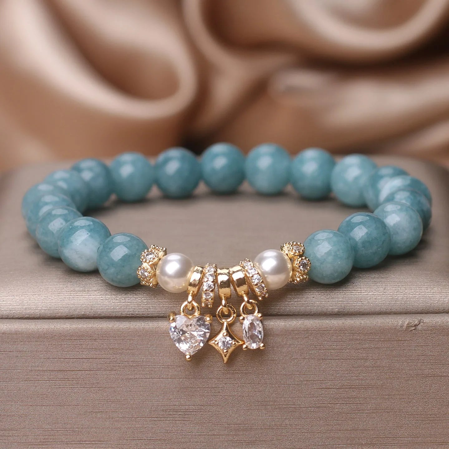 Blue water jade bracelet with heart-shaped zircon pendant and agate beads on display