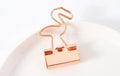 Small gold-plated metal office clip with a long tail, shown in a choice of flamingo, love, clouds, cat, and cactus shapes.