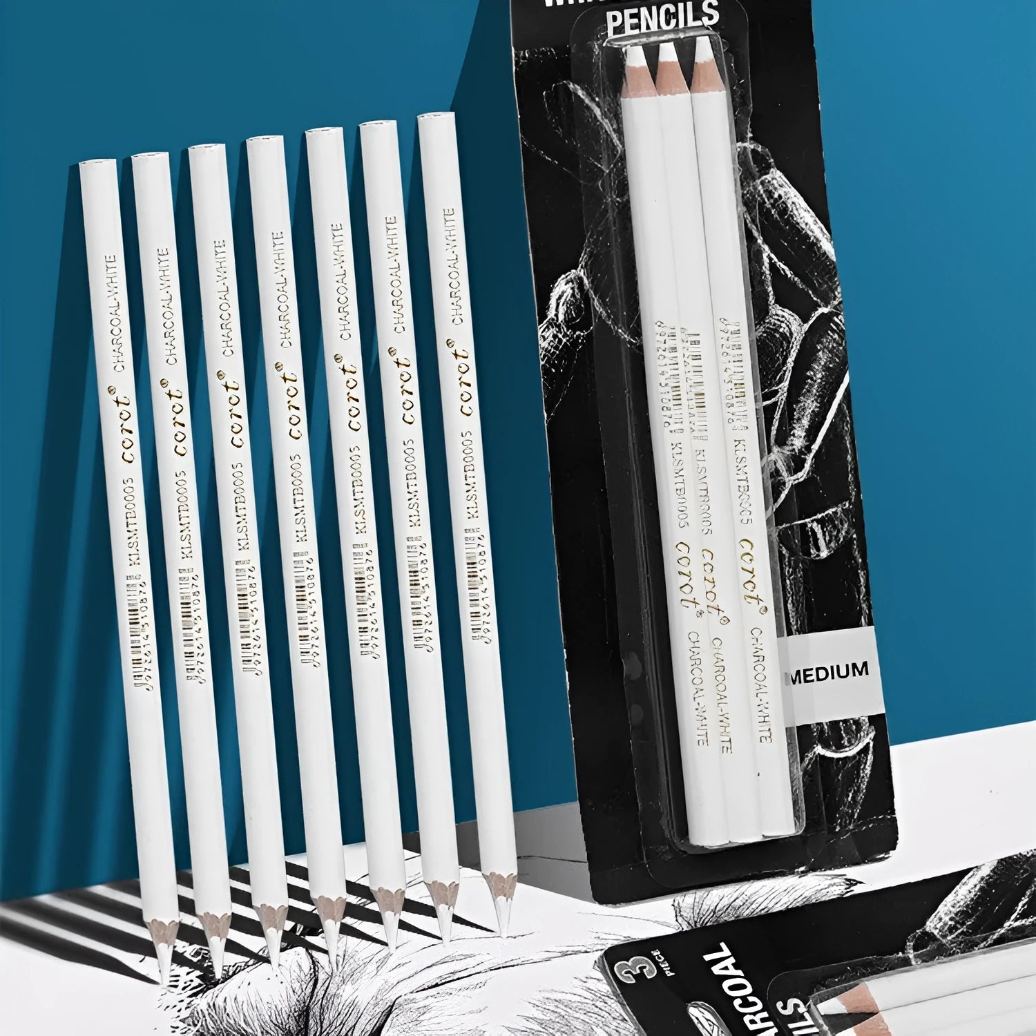 Three white charcoal pencils with wooden casings for sketching and highlighting on dark paper