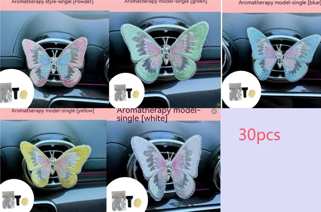 Fabric embroidered butterfly car air vent decoration in multiple colour options on a dashboard.