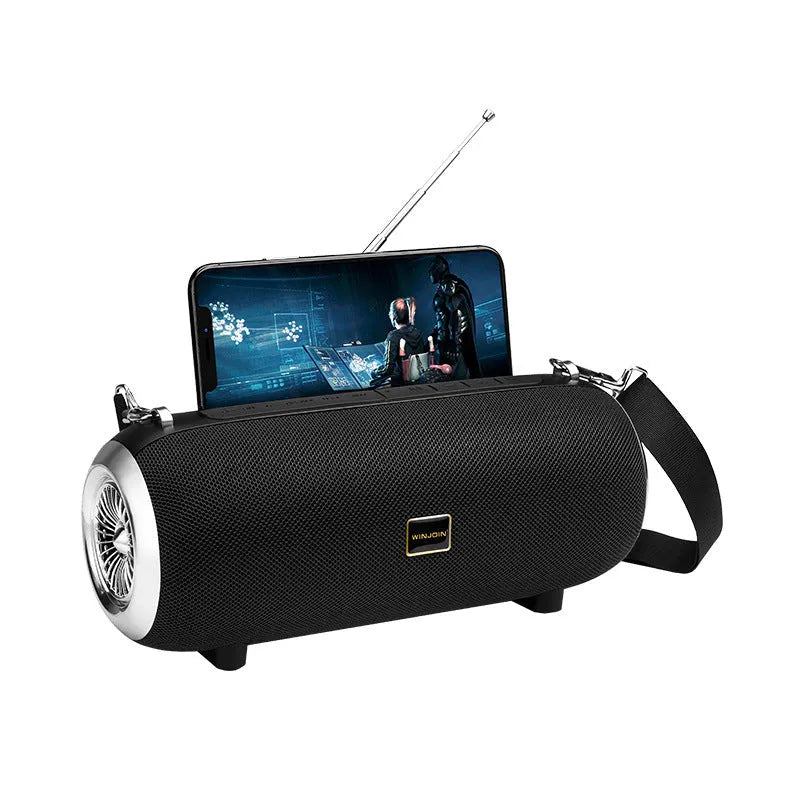 F666 portable Bluetooth speaker with fabric mesh finish, shoulder strap, and display showing FM radio frequency.