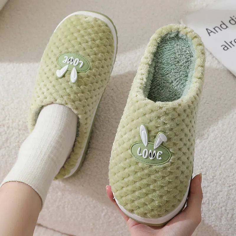 A pair of plush artificial fur house slippers with a baotou toe and a flat rubber sole, shown in a choice of colours.
