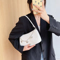 Women's black retro-style crossbody bag with chain strap and structured square shape.