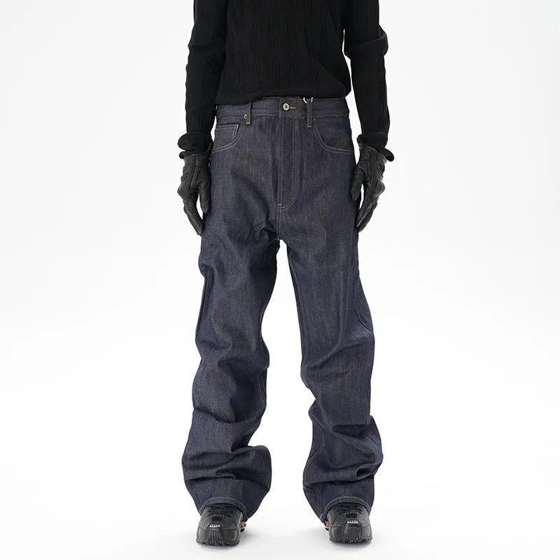 Man's dark blue loose-fit straight leg denim jeans on a neutral background.