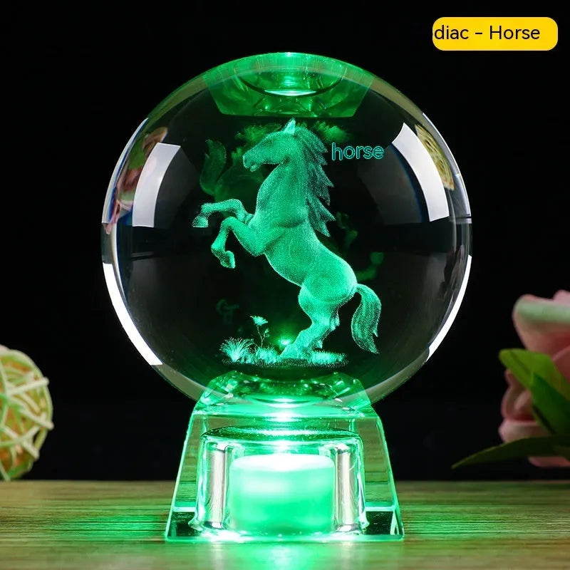 White crystal ball zodiac ornament with luminous electronic base showing Chinese animal designs
