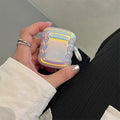 Silicone case with laser engraving and a coloured ring for Apple AirPods charging case.