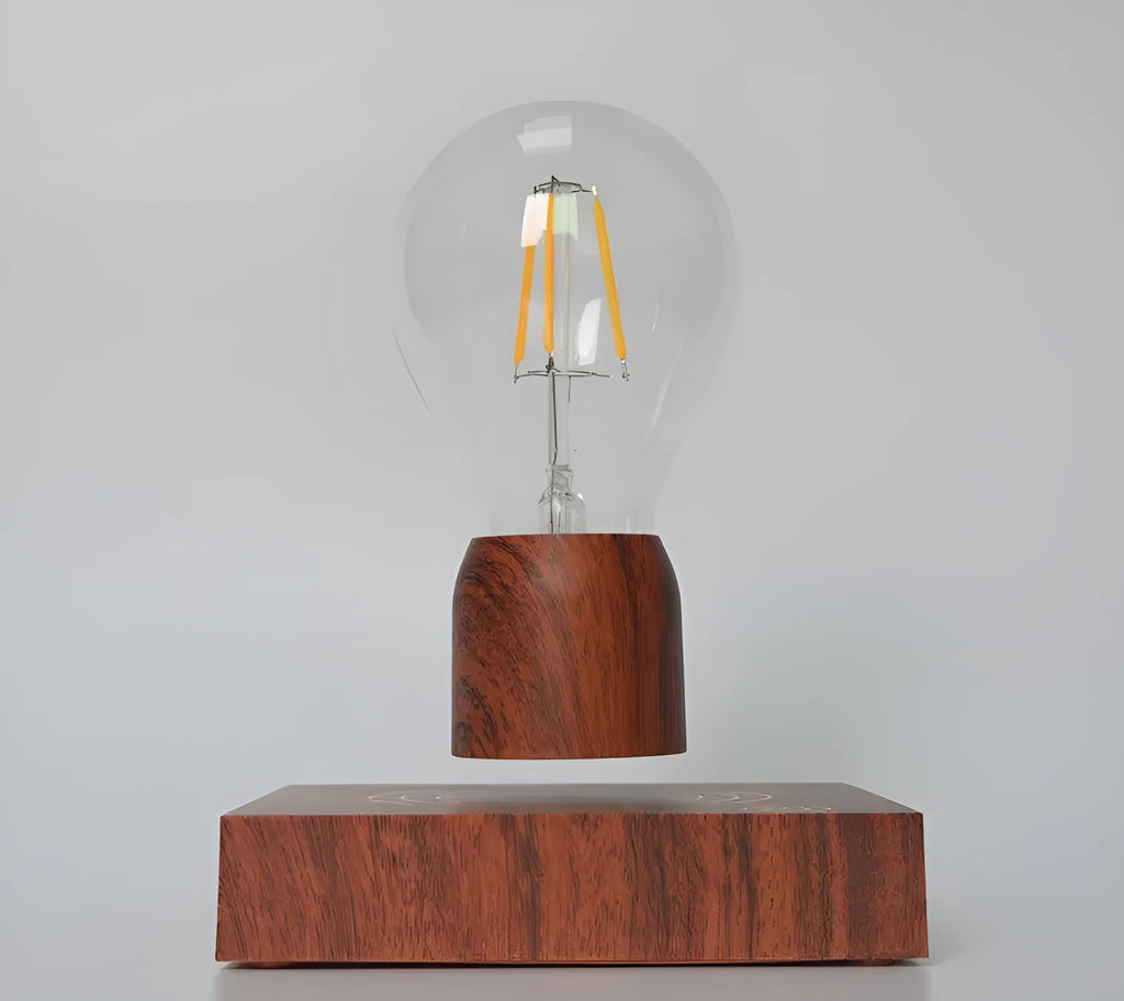 Magnetic levitation light bulb floating above its imitation wood base.