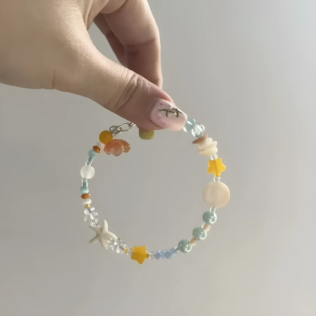 Alloy and mixed material seaside summer charm bracelet in colour Bracelet 0213 with diamond and round shapes.