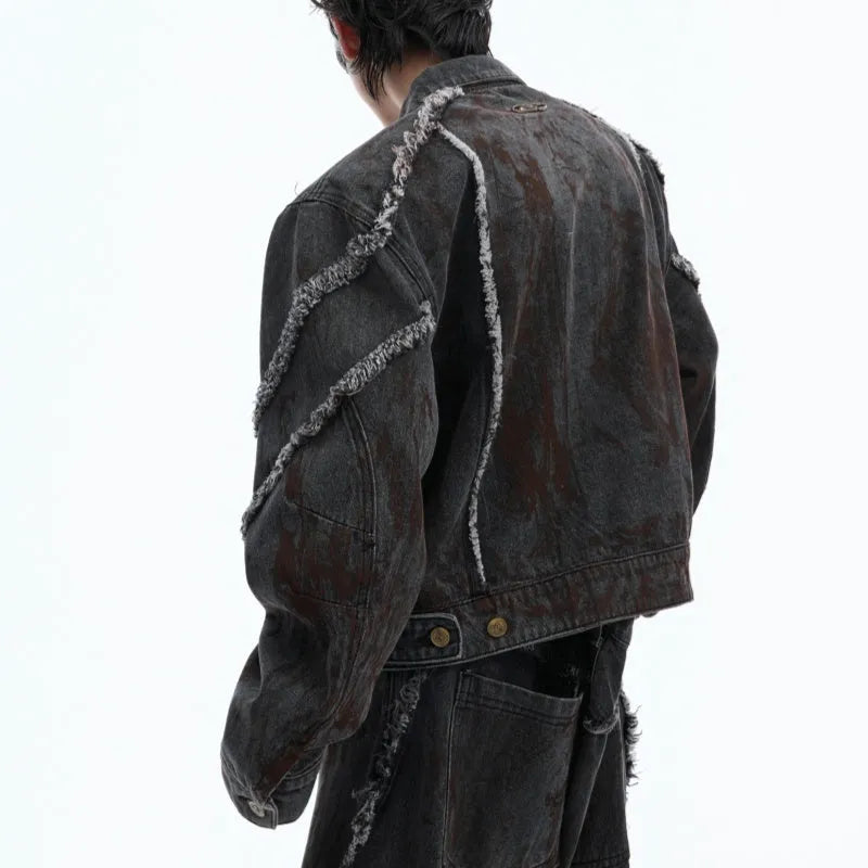 Black distressed denim coat and pants set with a gradient pattern and padded shoulders.