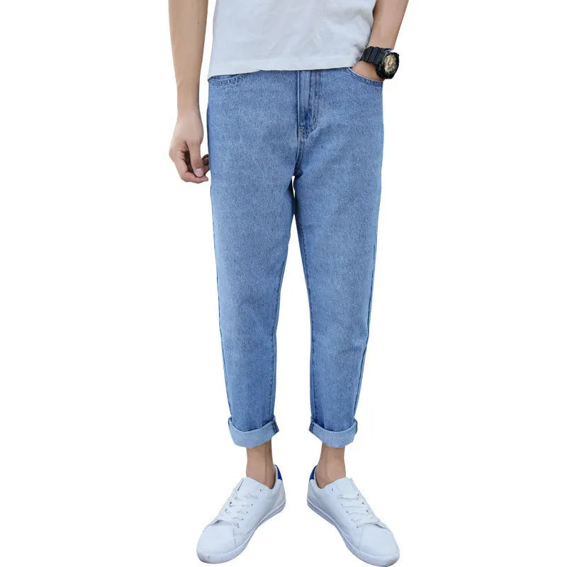 Men's black cotton straight-leg jeans with loose harem fit on adult male model