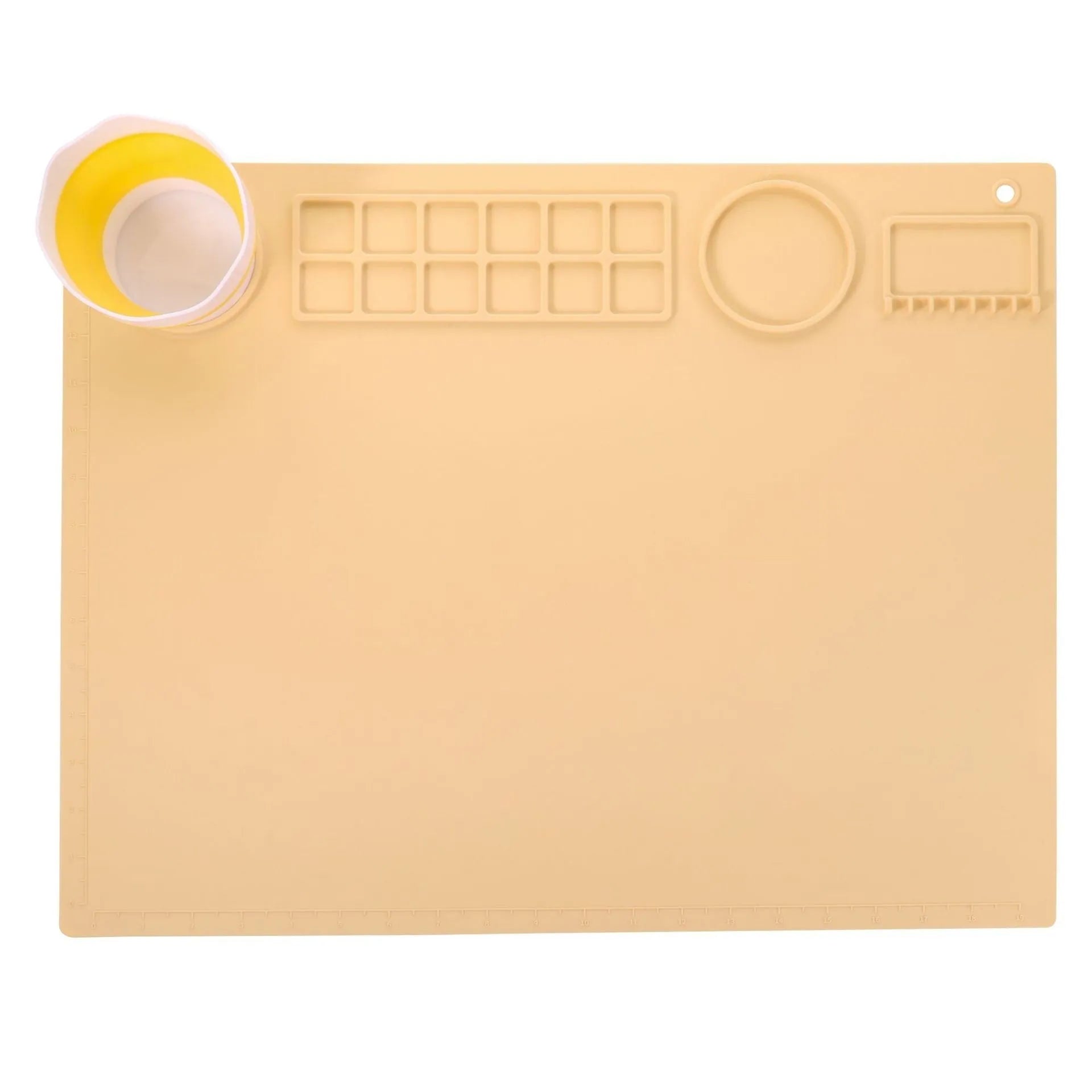 Light blue silicone painting mat with two moulded bowls for artists, size 50cm by 40cm.