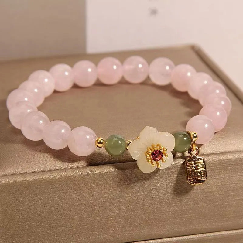 Crystal Hetian jade beaded bracelet with peach blossom design and camellia fruit elements