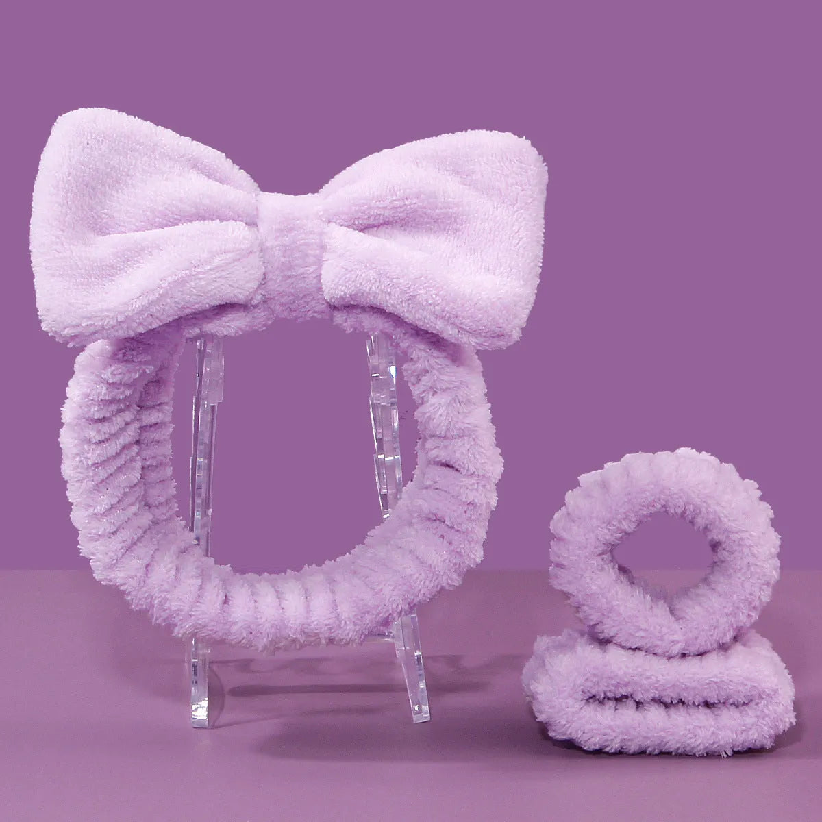 Facial brush and coral fleece hair band set in purple, grey, white, and pink colours.