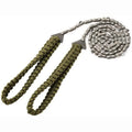 Braided umbrella rope camping survival pocket saw in army green with manganese steel blade, expanded to 103 cm, on natural wood surface