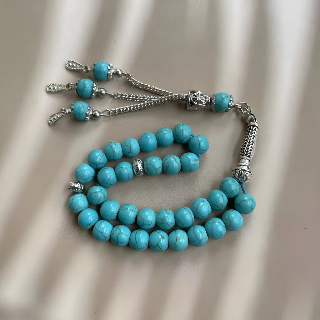 Handmade sky blue stone bead Muslim worship bracelet with 8mm beads on a white background