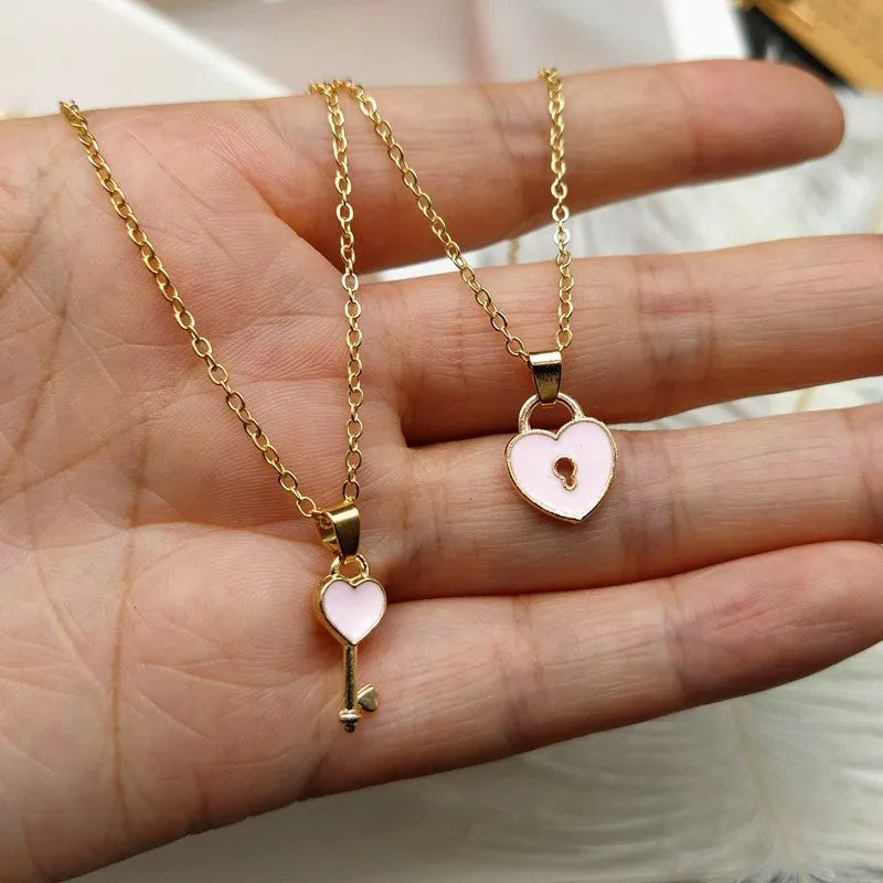 Small alloy lock and key pendant necklace set in black with 40cm chain on white background