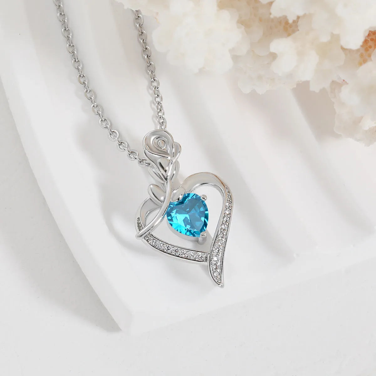 Rose heart-shaped necklace with rhinestones in copper electroplated finish, available in blue, purple, red, or white