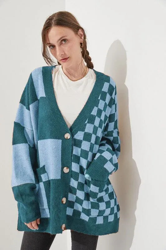 Loose fit knitwear cardigan with checks print in a selection of colours on a hanger.