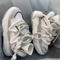 Grey women's retro clunky sneakers with thick rubber sole and lace-up front.