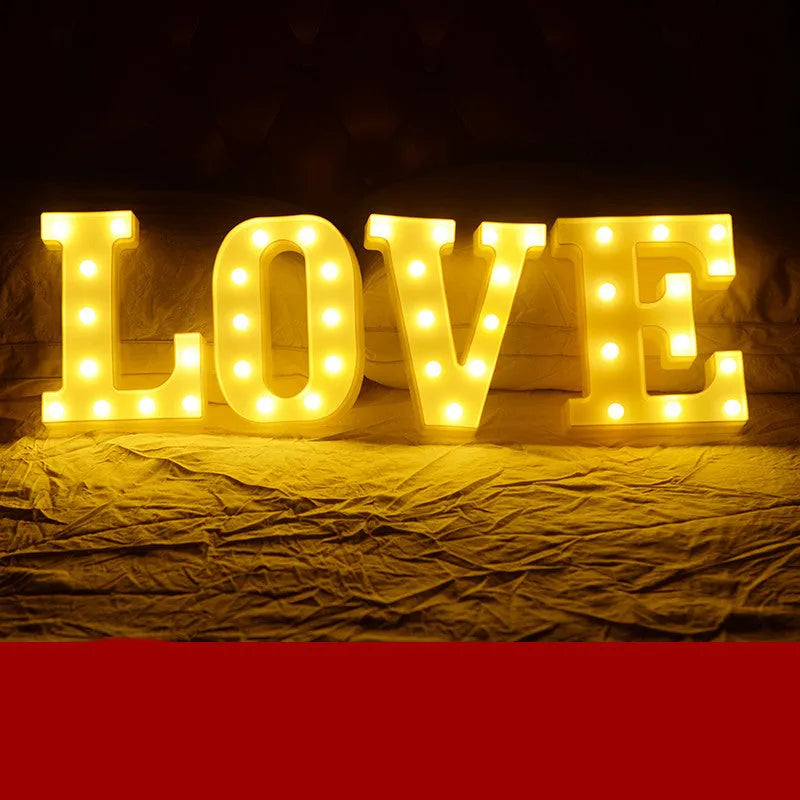 Plastic LED letter light decoration spelling a message, 22cm in height.