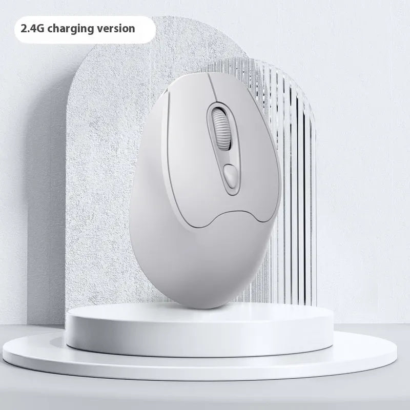 Bluetooth wireless mouse in choice of girl pink, milk tea pink, grey or green colours on a desk next to a laptop.