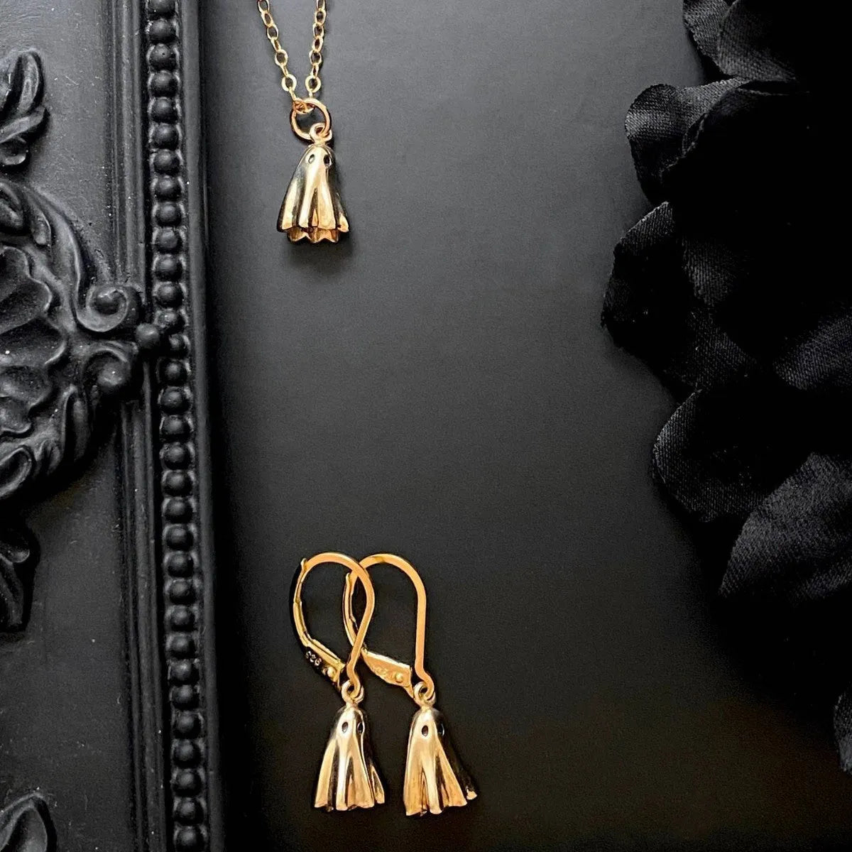 Ghost pendant necklace on a twisted stainless steel chain, shown in Cable, Figaro, and Mini Staple style options.