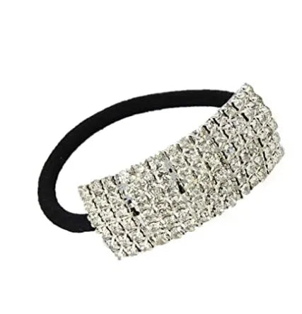 Three silver hair rings with rhinestone crystals on a light background
