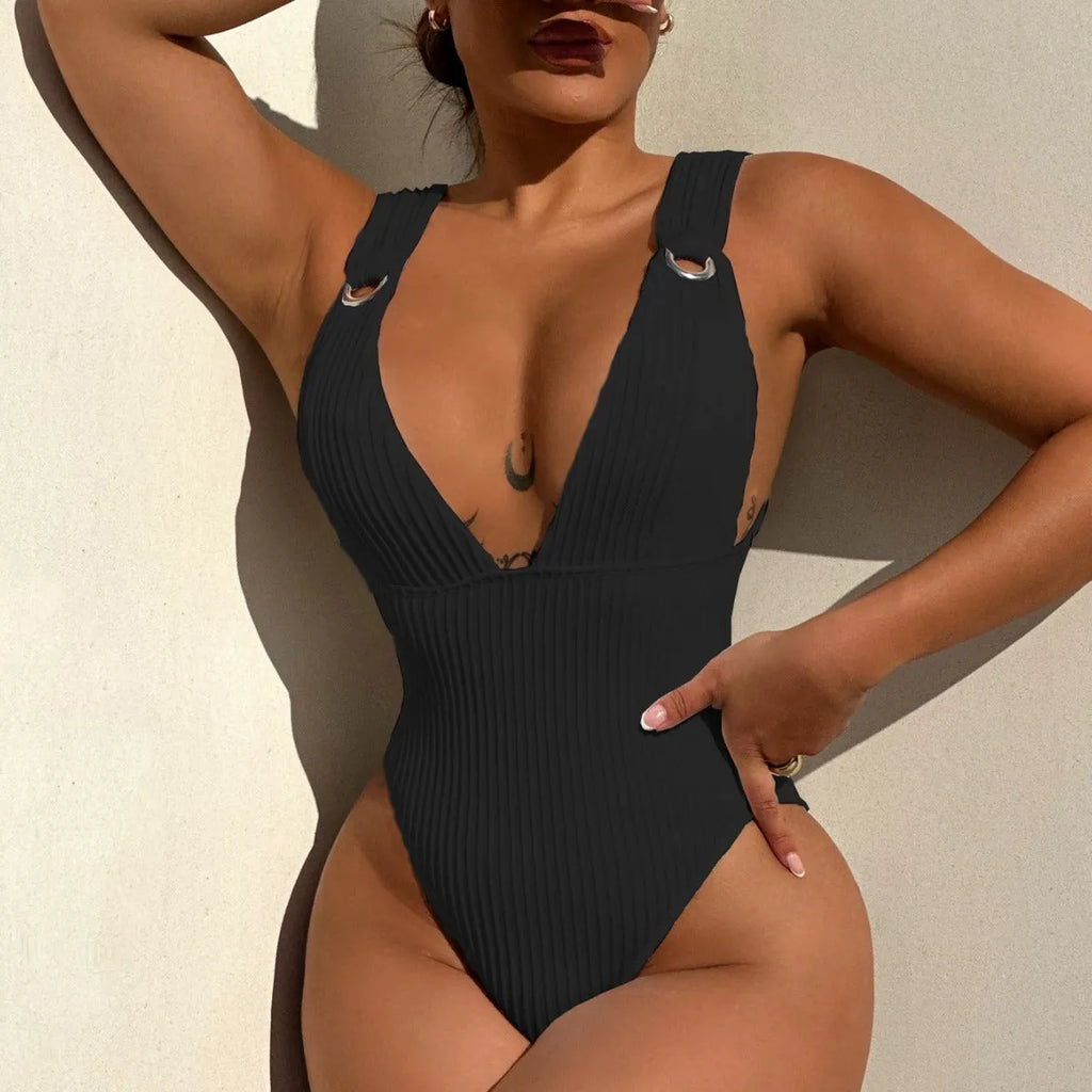 A solid colour one-piece swimsuit for women, shown in black, white, green, and orange colour options.