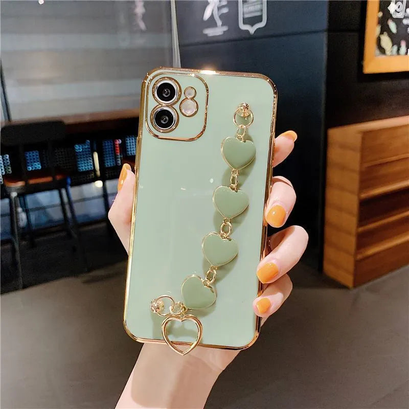 Silicone phone case with wrist bracelet for Samsung smartphones in solid green, pink, purple, or light green.