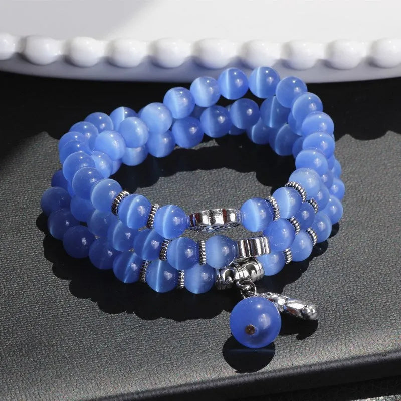Opal crystal cat eye bracelet with lucky cat charm, shown in one of six colour options.