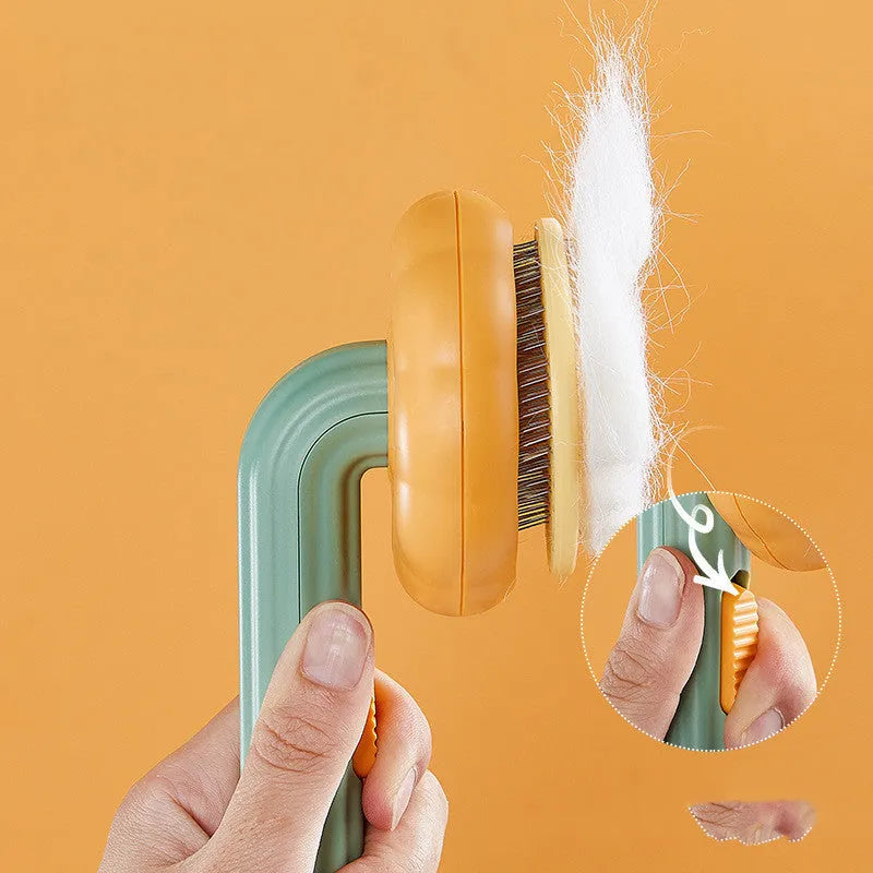 Self-cleaning pet cat brush with 232 steel needles in white or pumpkin colour, hand-held grooming tool