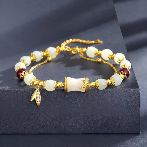 Retro style bamboo bracelet with coloured glass floral beads and ruyi design