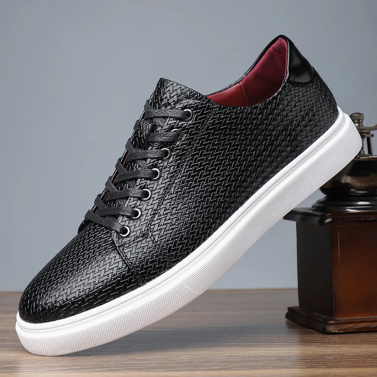Men's black low-top leather business shoes with stitched detailing and a rubber sole.