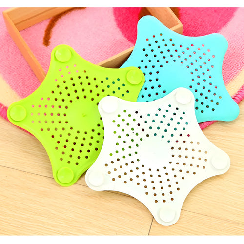 Three starfish-shaped TPR sink drain filters in blue, green, and white on a bathroom sink