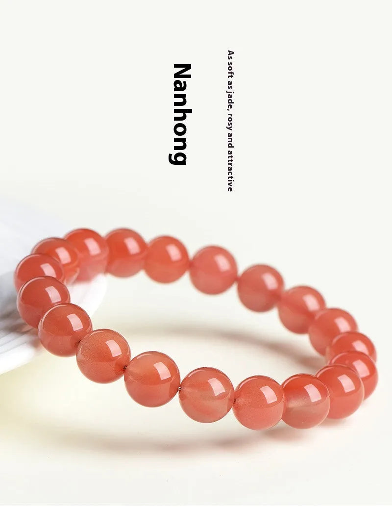 Natural South Cherry Red Agate bracelet with polished beads on an elasticated cord.